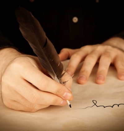 a man's hand holds the fountain pen and the signing of a contract closeup